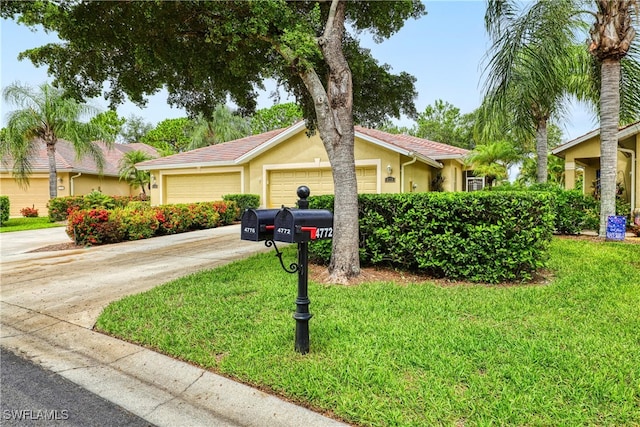 4776 Fairloop Run, Lehigh Acres, FL 33973 - ranch-style house featuring stucco siding, a front yard, driveway, and a garage