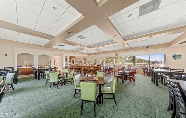 4776 Fairloop Run, Lehigh Acres, FL 33973 - carpeted dining area featuring coffered ceiling, arched walkways, and beamed ceiling