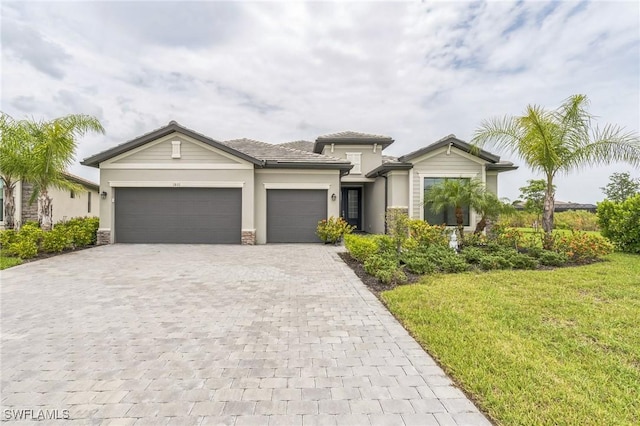 1801 Hagen Ct, Naples, FL 34120 - view of front of property featuring decorative driveway, an attached garage, a front lawn, and stucco siding