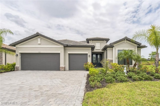 1801 Hagen Ct, Naples, FL 34120 - view of front of property with french doors, decorative driveway, a garage, stone siding, and stucco siding