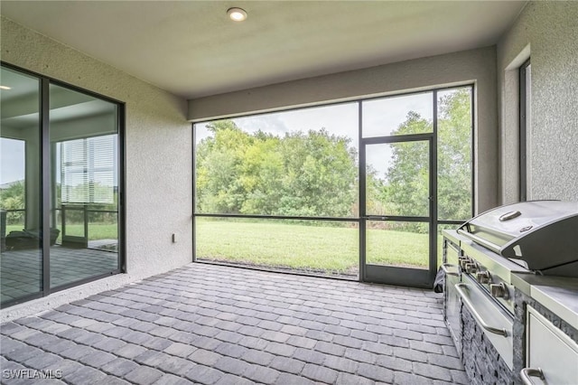 1801 Hagen Ct, Naples, FL 34120 - sunroom / solarium featuring healthy amount of natural light and an outdoor kitchen