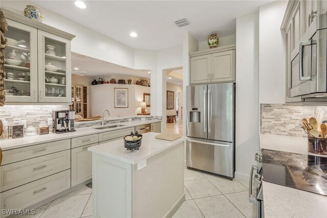 23751 Merano Ct Unit 201, Estero, FL 34134 - kitchen with stainless steel appliances, light tile patterned flooring, tasteful backsplash, and recessed lighting