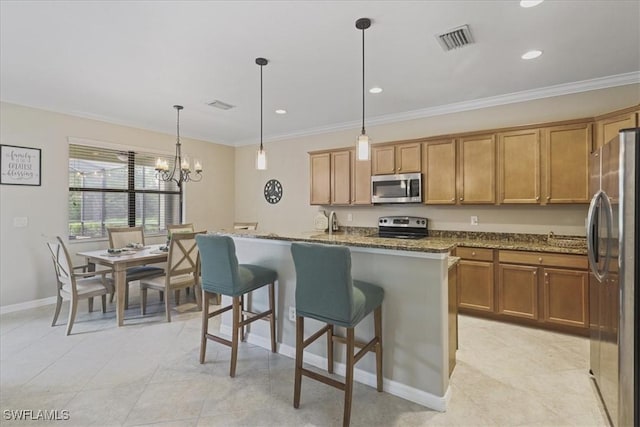 20333 Cypress Shadows Blvd, Estero, FL 33928 - kitchen featuring appliances with stainless steel finishes, dark stone counters, brown cabinetry, an island with sink, and crown molding