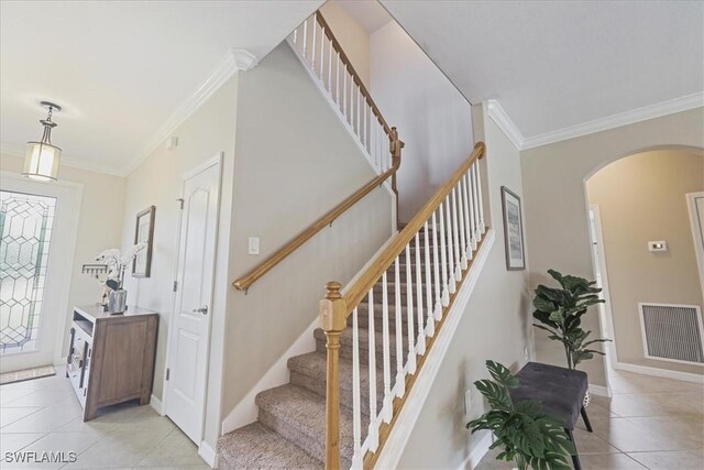 20333 Cypress Shadows Blvd, Estero, FL 33928 - foyer featuring arched walkways, ornamental molding, light tile patterned flooring, and stairway