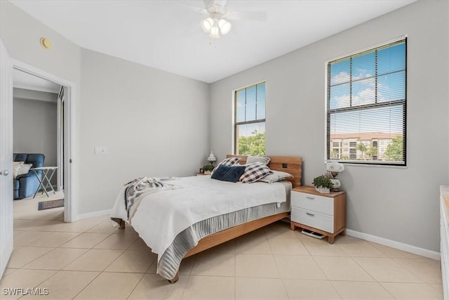 13010 Positano Cir Unit 206, Naples, FL 34105 - bedroom with light tile patterned flooring and a ceiling fan