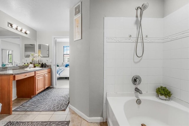 13010 Positano Cir Unit 206, Naples, FL 34105 - ensuite bathroom featuring vanity, plenty of natural light, tile patterned floors, and tub / shower combination