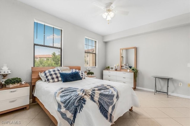 13010 Positano Cir Unit 206, Naples, FL 34105 - bedroom featuring light tile patterned flooring and a ceiling fan