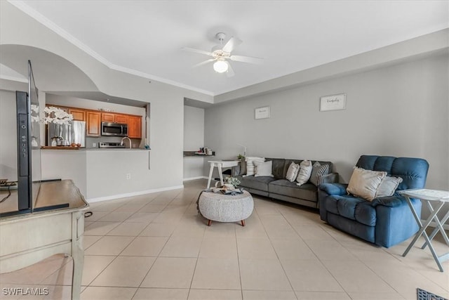 13010 Positano Cir Unit 206, Naples, FL 34105 - living room with a ceiling fan, light tile patterned floors, and crown molding
