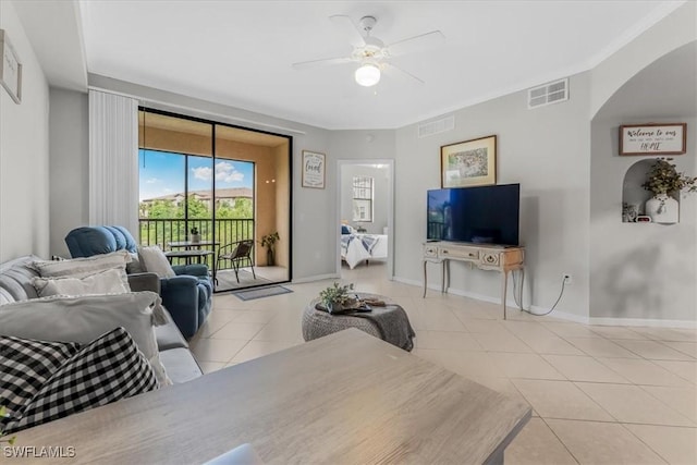 13010 Positano Cir Unit 206, Naples, FL 34105 - tiled living area featuring a ceiling fan and arched walkways