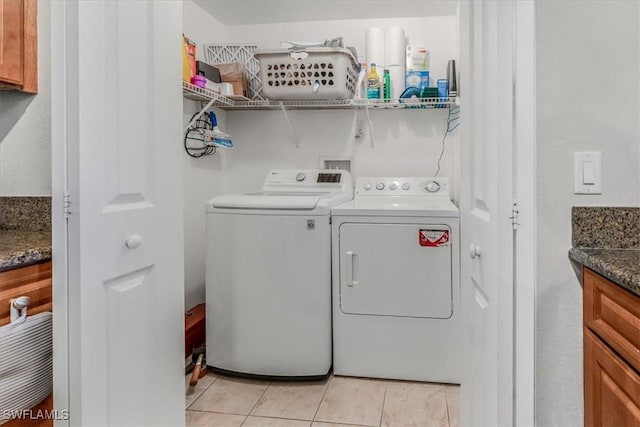 13010 Positano Cir Unit 206, Naples, FL 34105 - laundry area featuring separate washer and dryer and light tile patterned floors