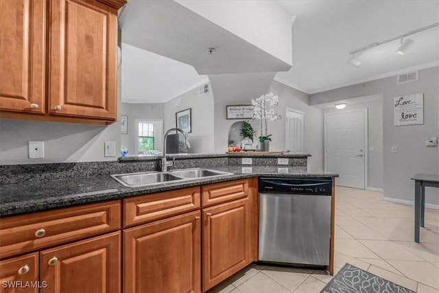 13010 Positano Cir Unit 206, Naples, FL 34105 - kitchen featuring dishwasher, ornamental molding, light tile patterned floors, brown cabinets, and dark stone countertops