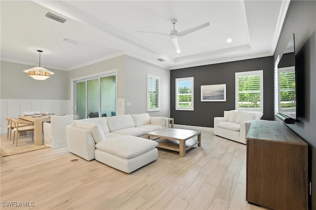 8951 Saint Lucia Dr, Naples, FL 34114 - living room with light wood-style floors, a tray ceiling, a ceiling fan, and ornamental molding