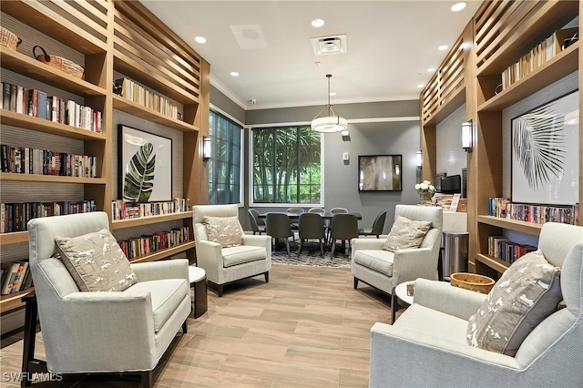 8951 Saint Lucia Dr, Naples, FL 34114 - sitting room with ornamental molding, light wood-style floors, recessed lighting, and built in shelves