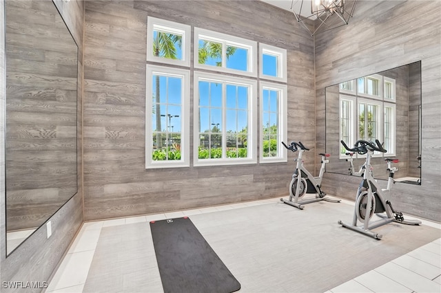 8951 Saint Lucia Dr, Naples, FL 34114 - exercise area featuring tile patterned floors and a chandelier