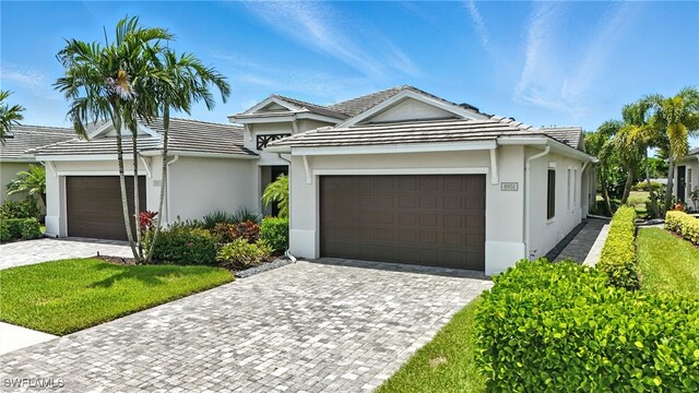 8951 Saint Lucia Dr, Naples, FL 34114 - ranch-style house featuring stucco siding, a garage, and driveway
