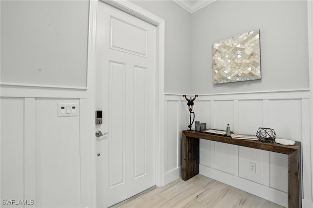 8951 Saint Lucia Dr, Naples, FL 34114 - entryway with crown molding, a decorative wall, and wainscoting