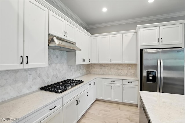 8951 Saint Lucia Dr, Naples, FL 34114 - kitchen featuring stainless steel appliances, under cabinet range hood, ornamental molding, white cabinetry, and light stone countertops