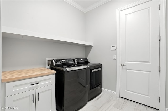 8951 Saint Lucia Dr, Naples, FL 34114 - laundry area featuring washing machine and clothes dryer, crown molding, light marble finish floors, and cabinet space