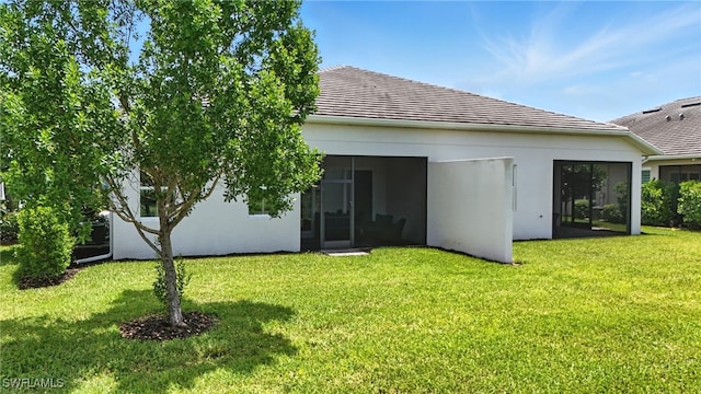 8951 Saint Lucia Dr, Naples, FL 34114 - rear view of house featuring a yard, a tile roof, and stucco siding