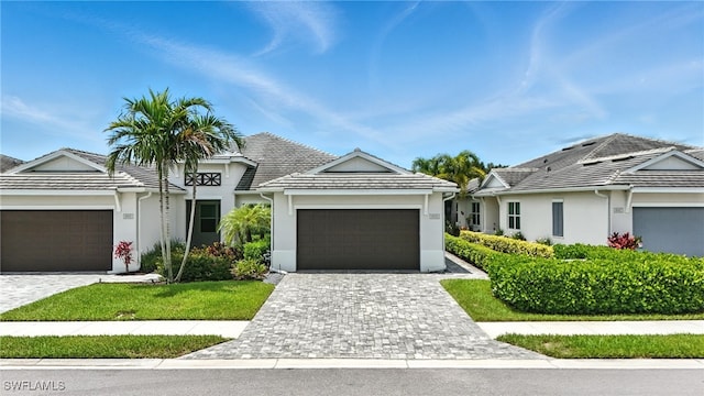 8951 Saint Lucia Dr, Naples, FL 34114 - single story home featuring a garage, stucco siding, decorative driveway, and a tile roof