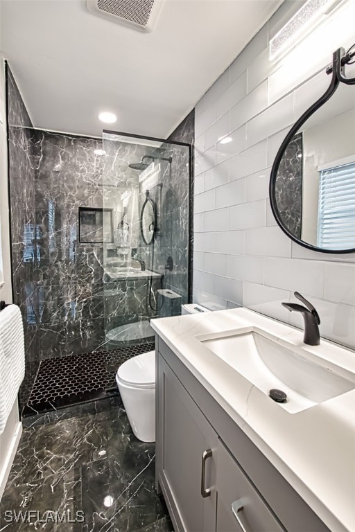 675 Logan Blvd S, Naples, FL 34119 - bathroom featuring tile walls, a marble finish shower, vanity, and marble finish floors