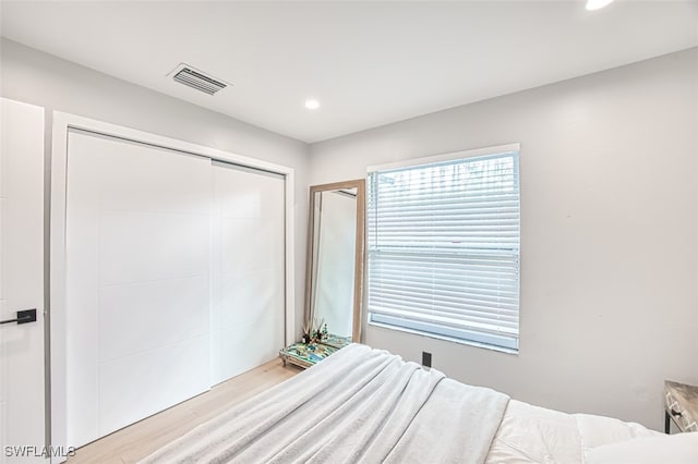 675 Logan Blvd S, Naples, FL 34119 - bedroom featuring light wood finished floors, recessed lighting, a closet, and multiple windows