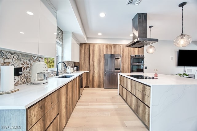 675 Logan Blvd S, Naples, FL 34119 - kitchen featuring black appliances, modern cabinets, island exhaust hood, light wood-style floors, and a spacious island