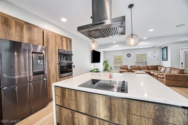 675 Logan Blvd S, Naples, FL 34119 - kitchen with smart refrigerator, wall chimney range hood, double wall oven, black electric cooktop, and light wood finished floors
