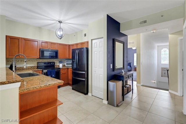 20310 Estero Gardens Cir Unit 203, Estero, FL 33928 - kitchen featuring black appliances, tasteful backsplash, stone counters, and light tile patterned floors