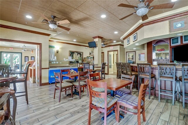 20310 Estero Gardens Cir Unit 203, Estero, FL 33928 - dining room with ceiling fan, crown molding, and light wood finished floors