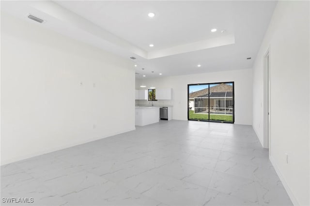 1021 Chiquita Blvd N, Cape Coral, FL 33993 - unfurnished living room featuring recessed lighting, a tray ceiling, and light marble finish flooring