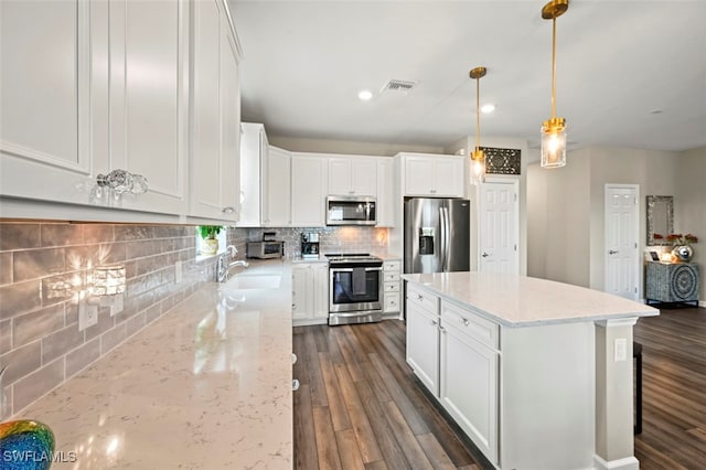 19280 Elston Way, Estero, FL 33928 - kitchen featuring stainless steel appliances, backsplash, dark wood-style floors, white cabinetry, and recessed lighting