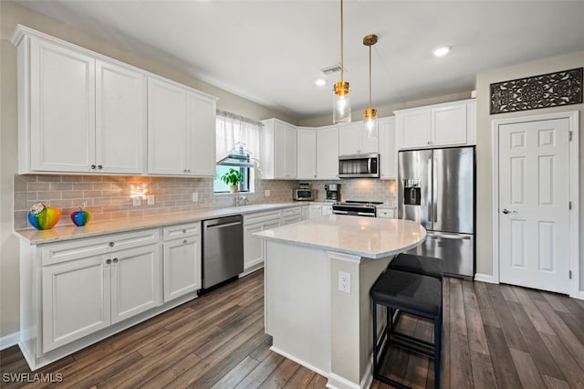 19280 Elston Way, Estero, FL 33928 - kitchen with appliances with stainless steel finishes, dark wood-style flooring, white cabinetry, and recessed lighting
