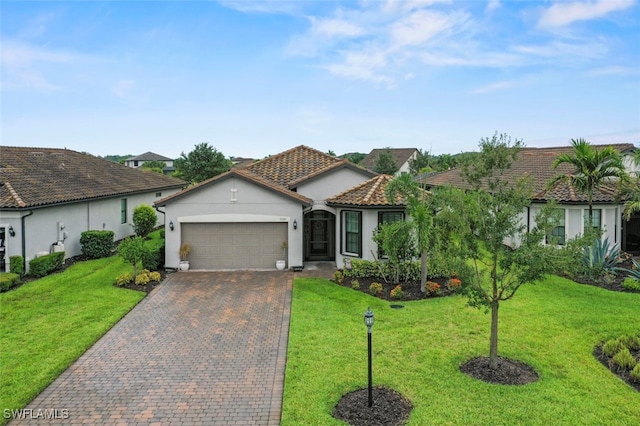19280 Elston Way, Estero, FL 33928 - view of front of property with a garage, stucco siding, decorative driveway, and a front yard