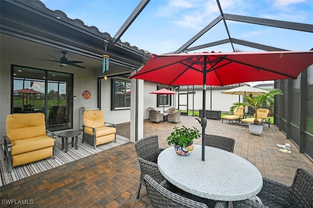 19280 Elston Way, Estero, FL 33928 - view of patio featuring ceiling fan, outdoor dining space, and glass enclosure