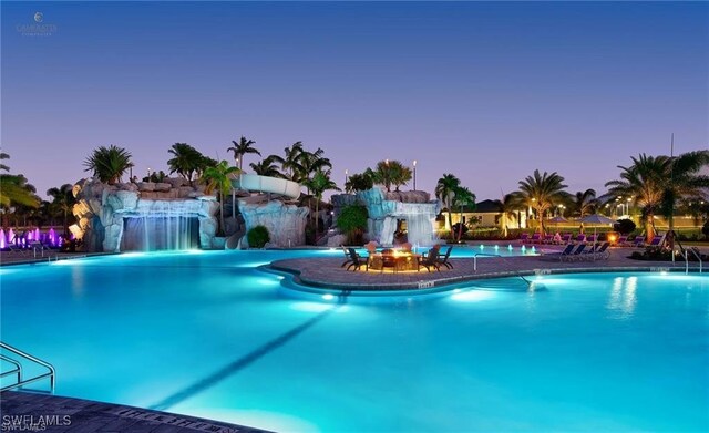 19280 Elston Way, Estero, FL 33928 - pool at dusk featuring a community pool and a patio area