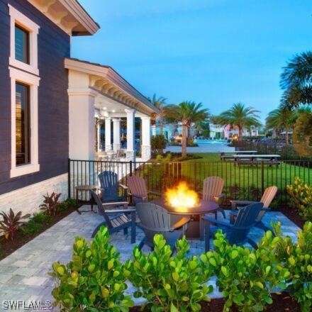 19280 Elston Way, Estero, FL 33928 - view of patio featuring an outdoor fire pit and a water view