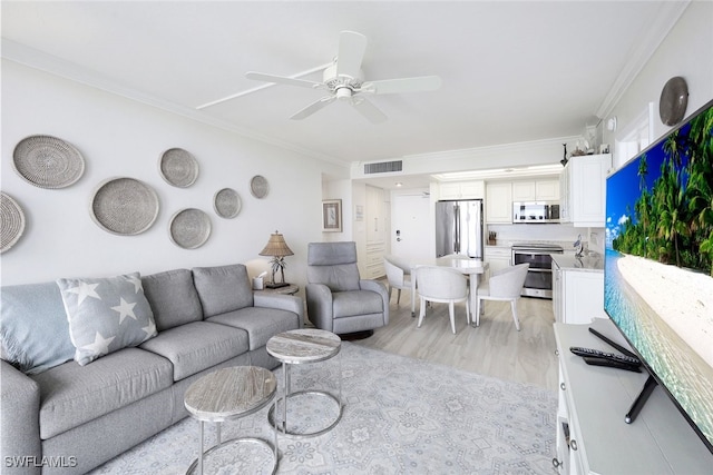 180 Seaview Ct Unit 215, Marco Island, FL 34145 - living room with ornamental molding, light wood-type flooring, and ceiling fan