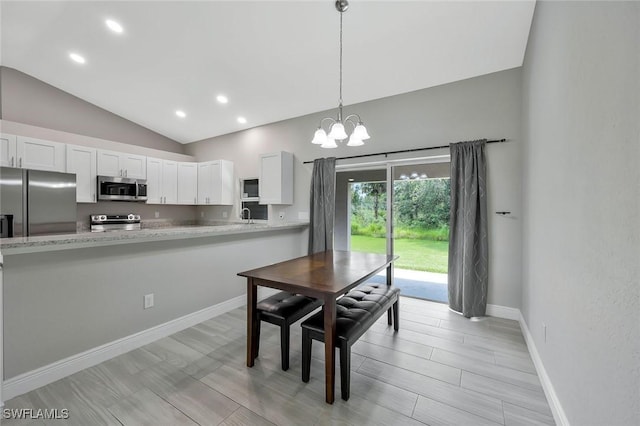 1417 Acacia Ave, Lehigh Acres, FL 33972 - dining space with vaulted ceiling, a chandelier, and recessed lighting