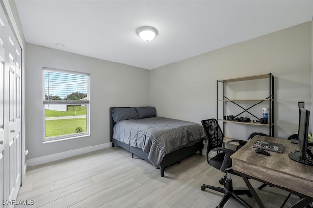1417 Acacia Ave, Lehigh Acres, FL 33972 - bedroom with an office area and light wood-style flooring
