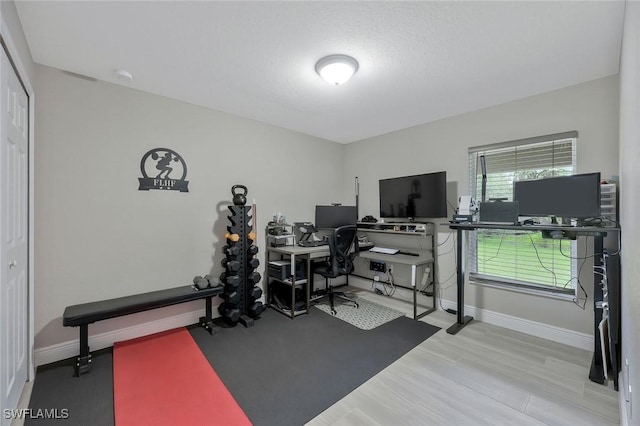 1417 Acacia Ave, Lehigh Acres, FL 33972 - workout room featuring baseboards and wood finished floors
