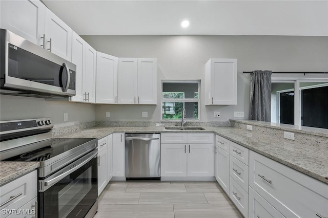 1417 Acacia Ave, Lehigh Acres, FL 33972 - kitchen featuring appliances with stainless steel finishes, white cabinets, light stone countertops, and recessed lighting