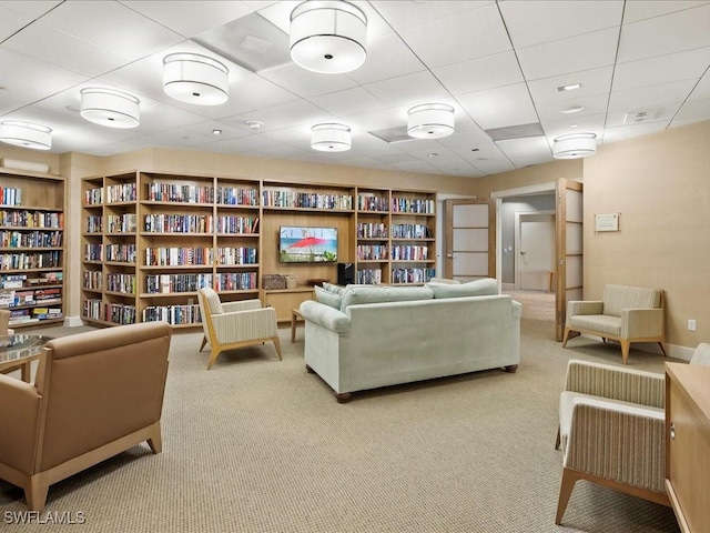 4651 Gulf Shore Blvd N Unit 1605, Naples, FL 34103 - living area with carpet floors, wall of books, built in features, and a drop ceiling
