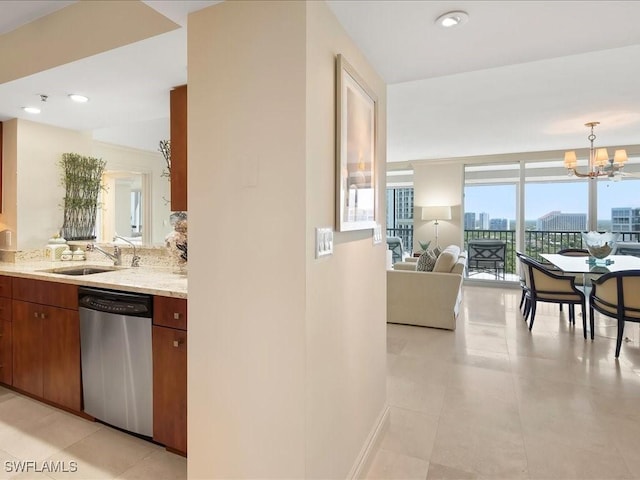 4651 Gulf Shore Blvd N Unit 1605, Naples, FL 34103 - kitchen featuring stainless steel dishwasher, a chandelier, light stone counters, open floor plan, and light tile patterned floors