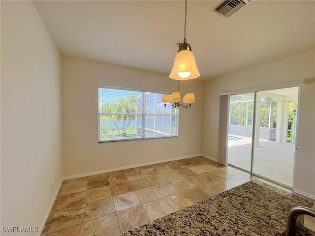 812 Grand Rapids Blvd, Naples, FL 34120 - spare room with a chandelier and baseboards