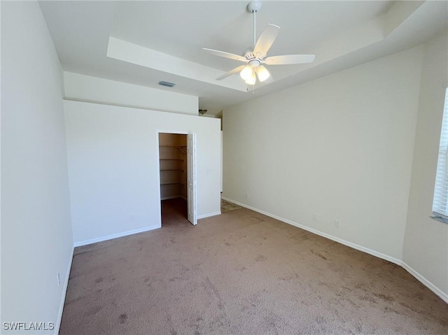 812 Grand Rapids Blvd, Naples, FL 34120 - unfurnished bedroom featuring carpet flooring, a raised ceiling, a closet, and ceiling fan