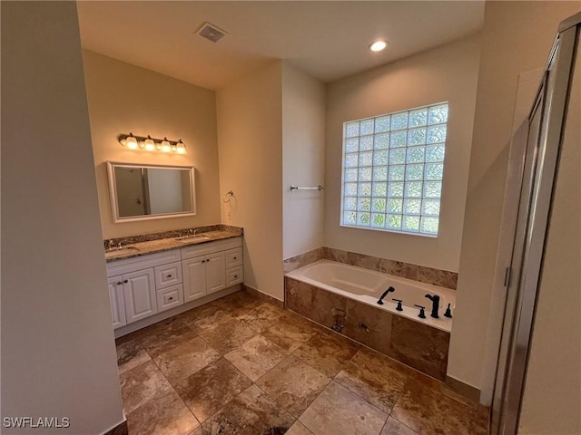 812 Grand Rapids Blvd, Naples, FL 34120 - bathroom with a garden tub, double vanity, a shower with shower door, stone finish floors, and recessed lighting