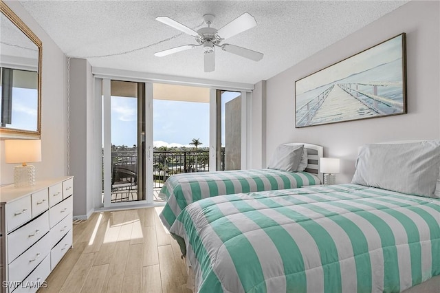 180 Seaview Ct Unit 612, Marco Island, FL 34145 - bedroom with multiple windows, access to outside, light wood-style flooring, a textured ceiling, and ceiling fan