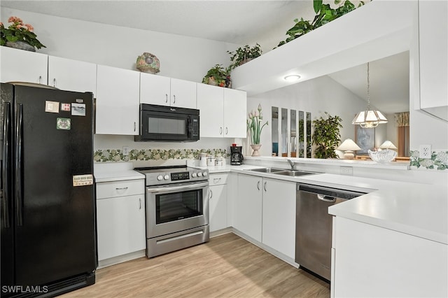 800 New Waterford Dr Unit A202, Naples, FL 34104 - kitchen with black appliances, light countertops, white cabinets, light wood-type flooring, and pendant lighting