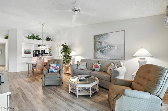 800 New Waterford Dr Unit A202, Naples, FL 34104 - living area with light wood-style flooring, lofted ceiling, a ceiling fan, and a textured ceiling
